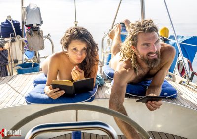 Naked Couple Reading on a boat