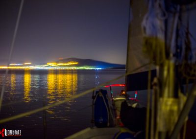 Sailboat heading into Vonitsa, Greece at night